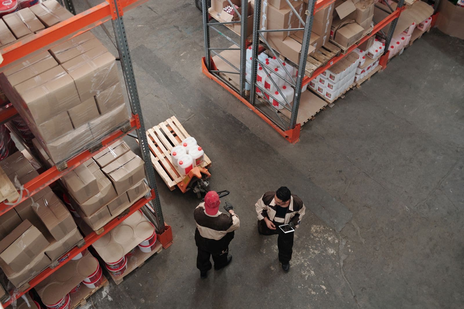 Warehouse staff working among shelving during a picking shift