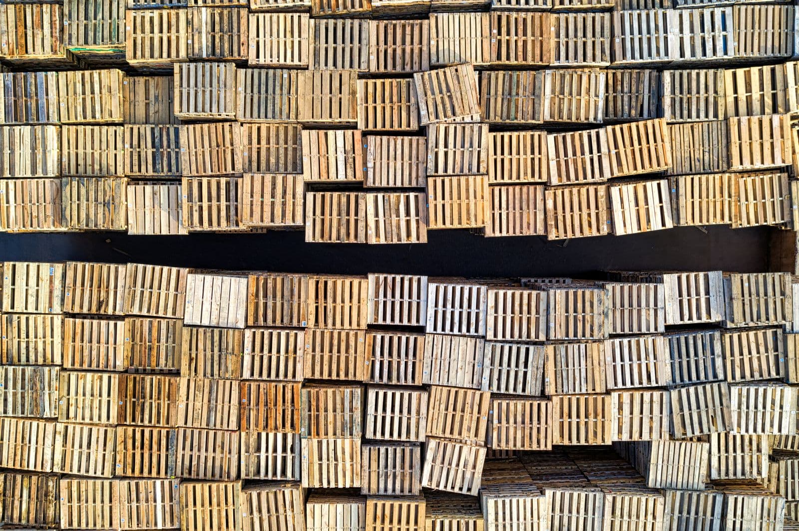 Stacked wooden pallets in a warehouse storage area